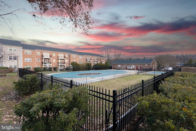 view of pool at dusk