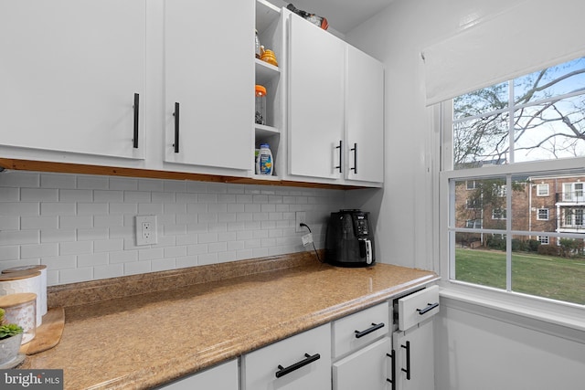 kitchen featuring white cabinetry and tasteful backsplash