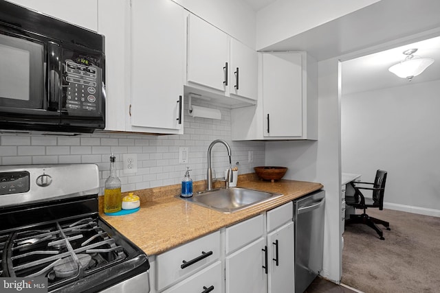 kitchen with stainless steel appliances, white cabinetry, tasteful backsplash, and sink