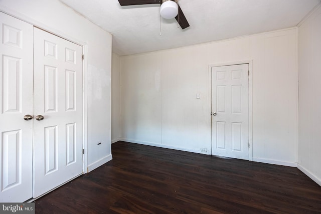 unfurnished bedroom with dark hardwood / wood-style floors and ceiling fan