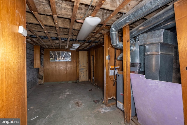 basement featuring wood walls