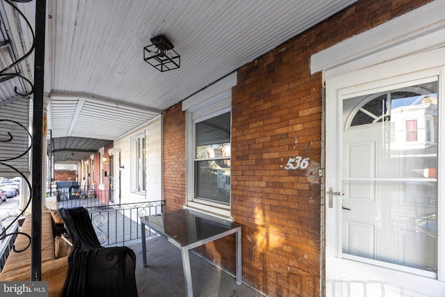 view of exterior entry with covered porch