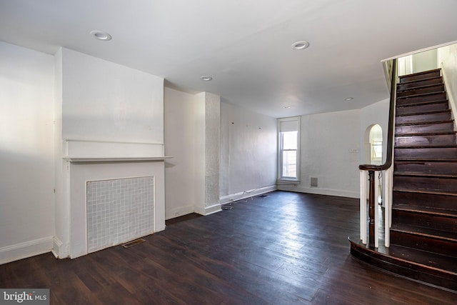 unfurnished living room with dark hardwood / wood-style floors