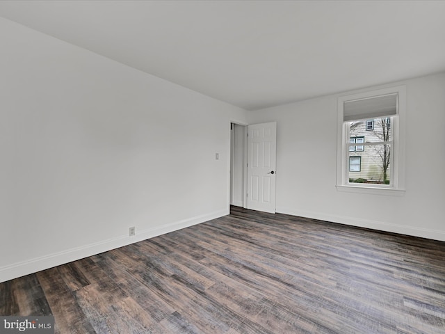 unfurnished room with dark hardwood / wood-style floors