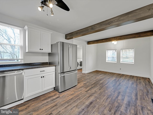 kitchen featuring white cabinets, appliances with stainless steel finishes, plenty of natural light, and washing machine and clothes dryer