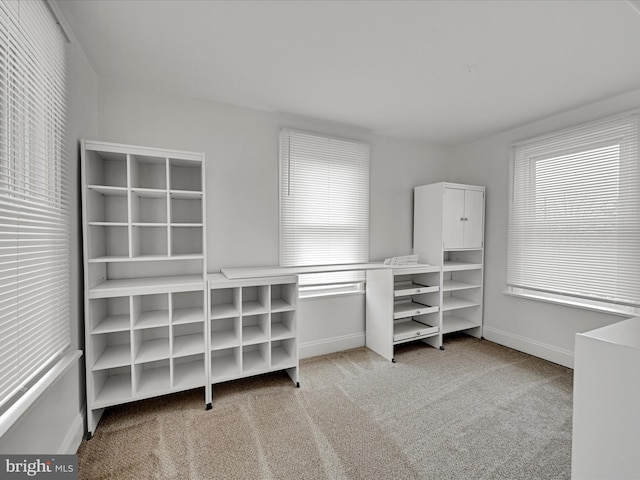 walk in closet featuring light colored carpet