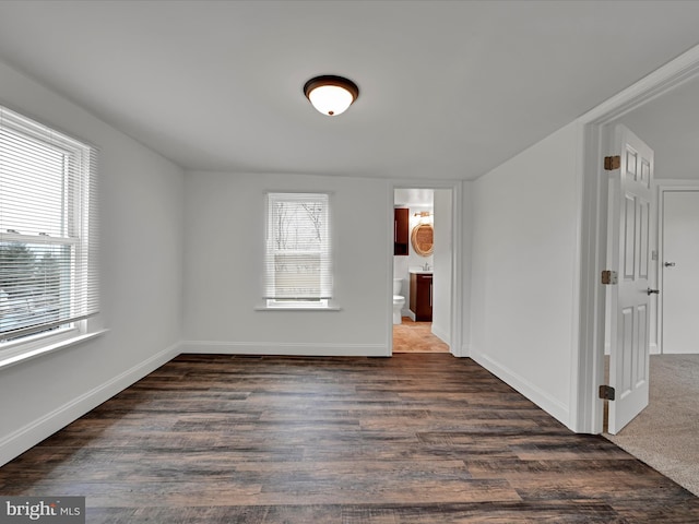 unfurnished room with dark hardwood / wood-style flooring