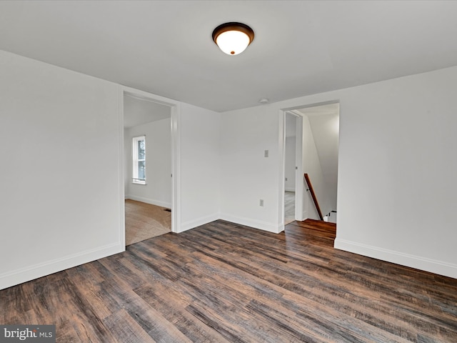 unfurnished room featuring dark hardwood / wood-style flooring