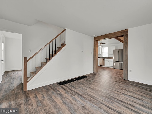 interior space with dark hardwood / wood-style floors and ceiling fan