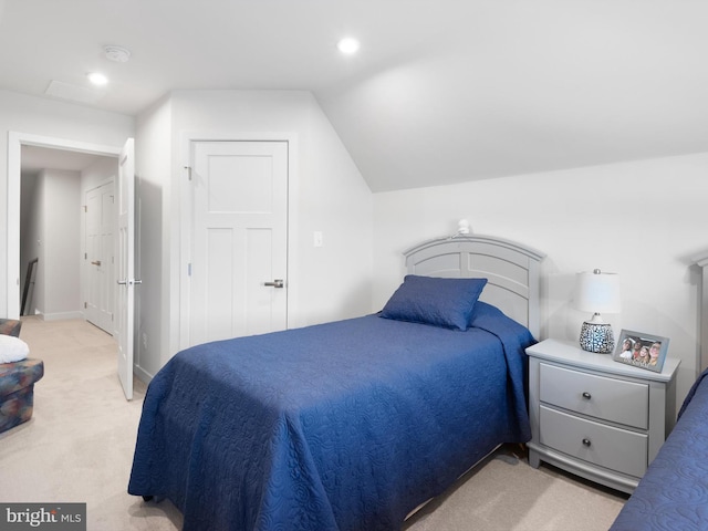 bedroom with light carpet and vaulted ceiling