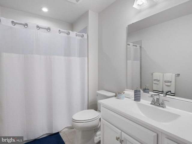 bathroom featuring tile patterned floors, a shower with curtain, vanity, and toilet