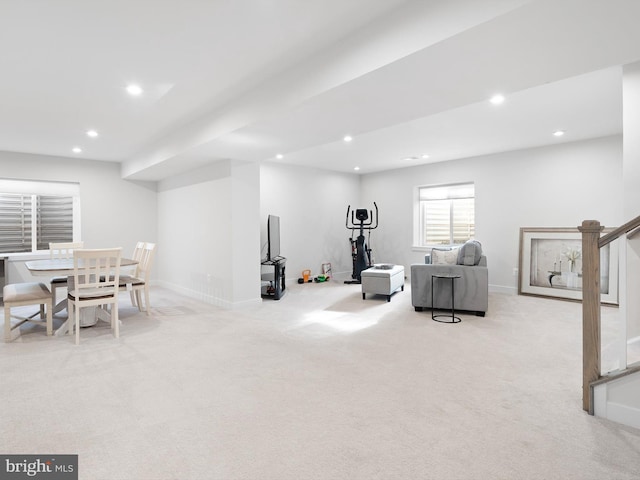 workout room featuring light carpet