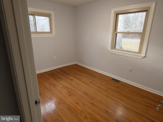 empty room featuring hardwood / wood-style flooring