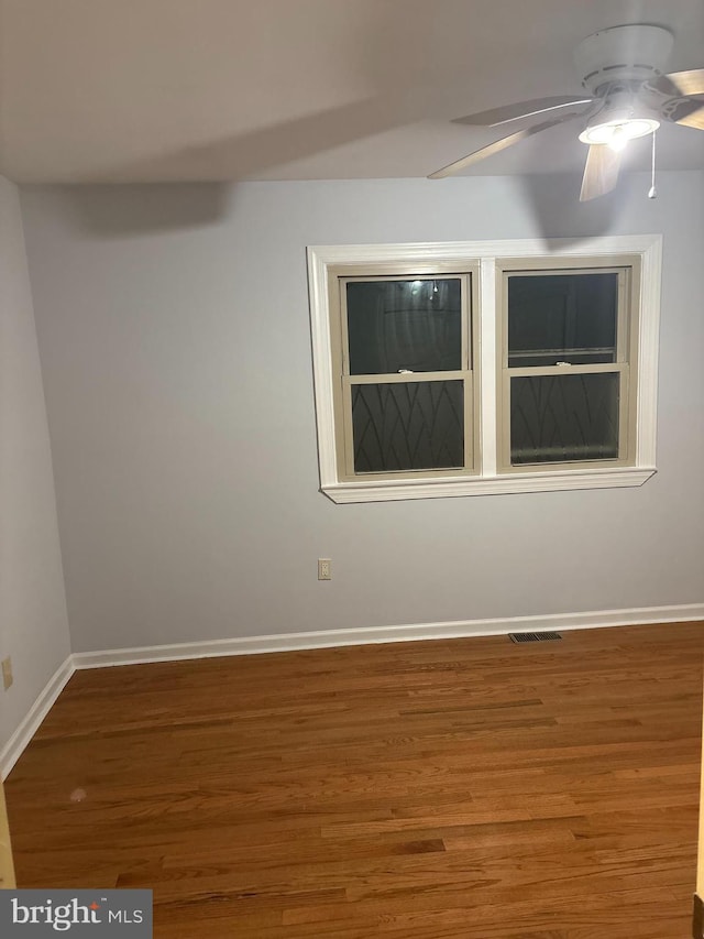 empty room with hardwood / wood-style flooring and ceiling fan