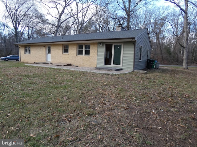 back of property featuring a lawn