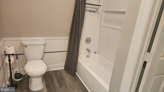 bathroom featuring hardwood / wood-style floors, shower / bath combination with curtain, and toilet