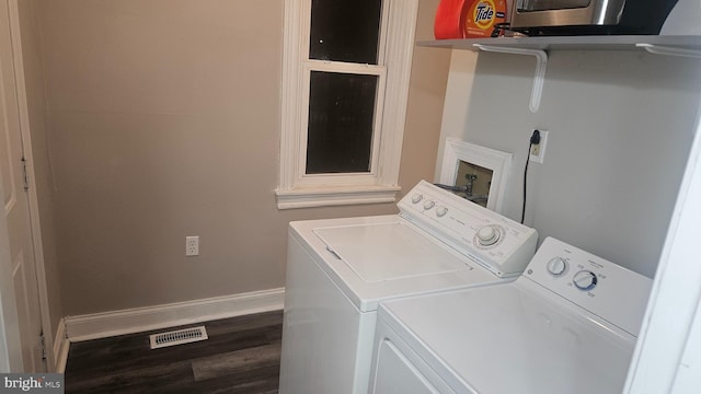 laundry room featuring washer and clothes dryer and hardwood / wood-style flooring