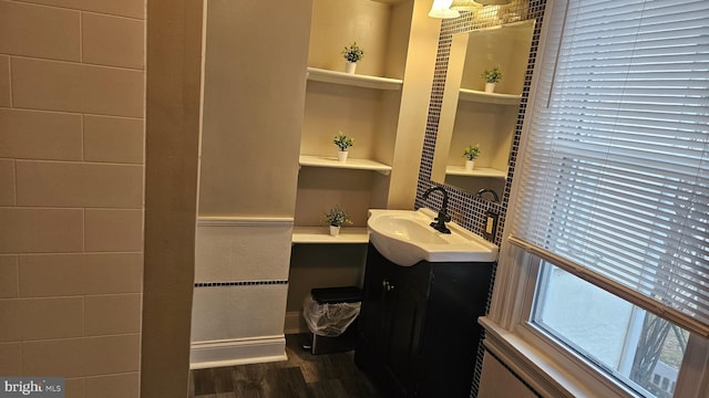 bathroom with hardwood / wood-style flooring, vanity, and built in features