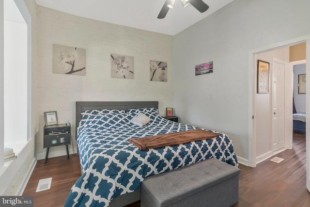 bedroom with dark hardwood / wood-style floors and ceiling fan