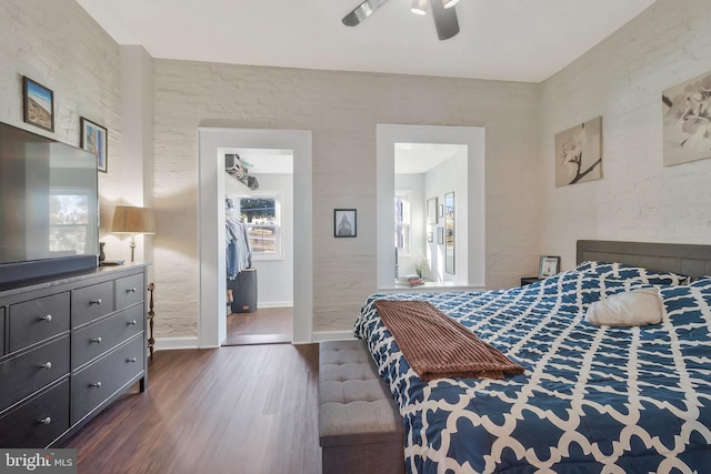 bedroom with multiple windows, dark hardwood / wood-style flooring, and ceiling fan