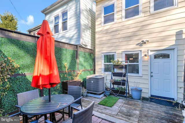 wooden deck featuring central AC unit