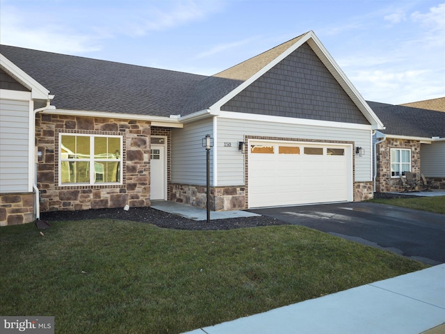 view of front of property with a front yard and a garage