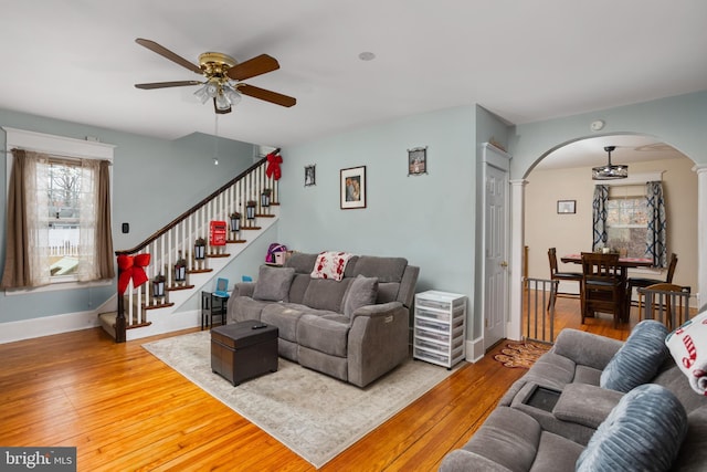 living room with wood-type flooring and ceiling fan