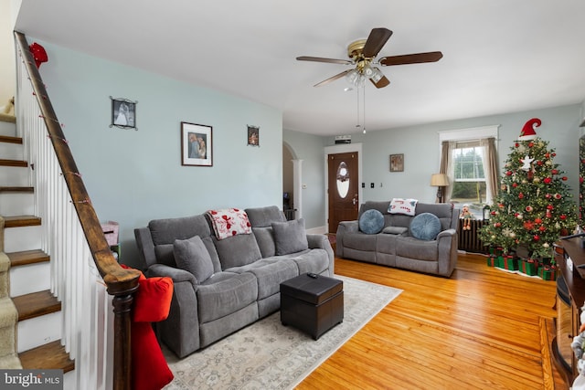 living room with wood-type flooring and ceiling fan