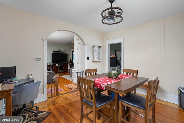 dining area with hardwood / wood-style floors and ceiling fan