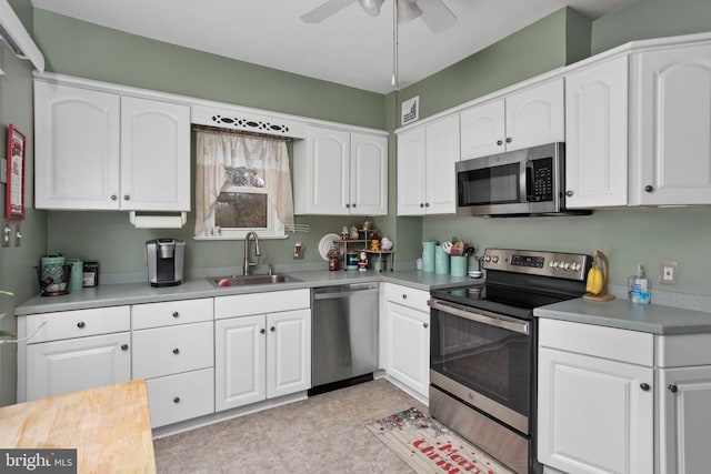 kitchen featuring white cabinetry, sink, ceiling fan, and appliances with stainless steel finishes