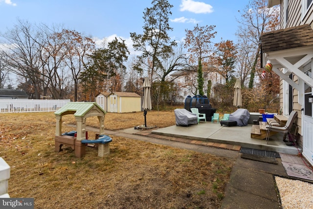 view of yard featuring a patio and a storage shed