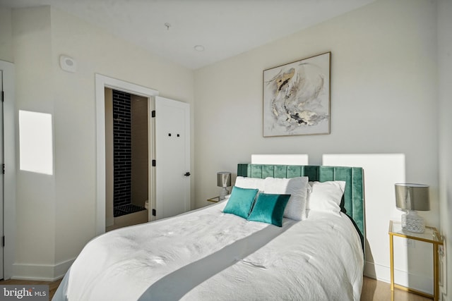 bedroom featuring wood-type flooring and a closet