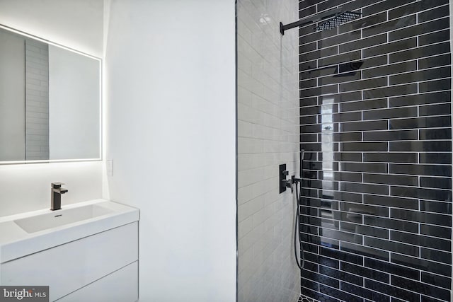 bathroom featuring vanity and tiled shower