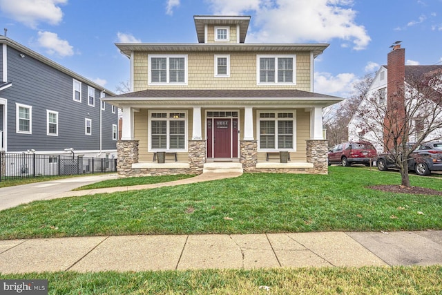 view of front of home featuring a front lawn and covered porch