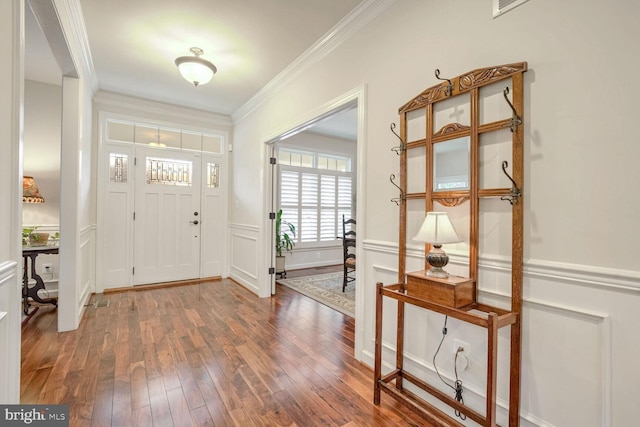 entrance foyer with ornamental molding and hardwood / wood-style floors