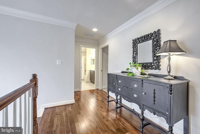 hallway with hardwood / wood-style flooring and ornamental molding