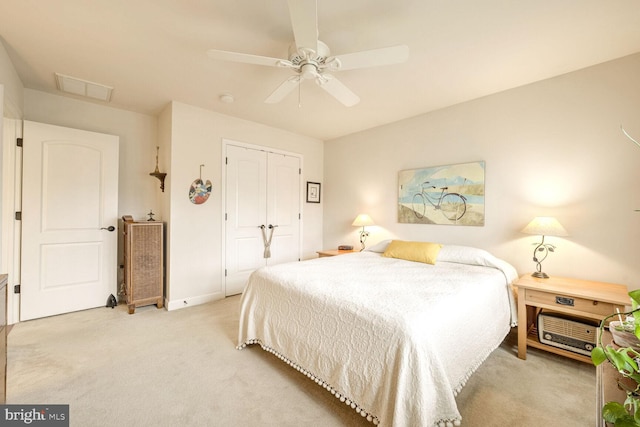 bedroom featuring light colored carpet, a closet, and ceiling fan