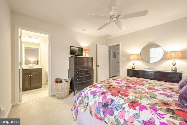 bedroom featuring light carpet, sink, connected bathroom, and ceiling fan