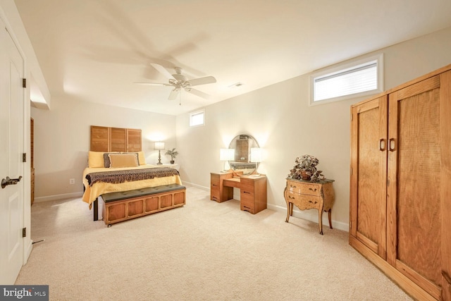 carpeted bedroom with multiple windows and ceiling fan