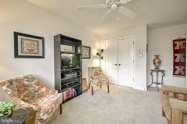 sitting room with ceiling fan and carpet flooring