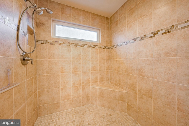 bathroom featuring a tile shower