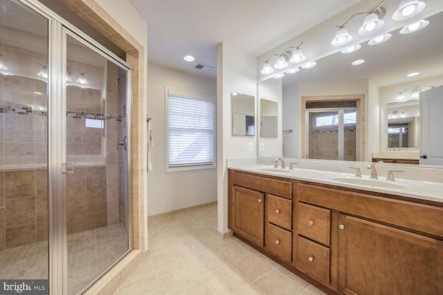 bathroom with vanity, tile patterned flooring, and a shower with shower door