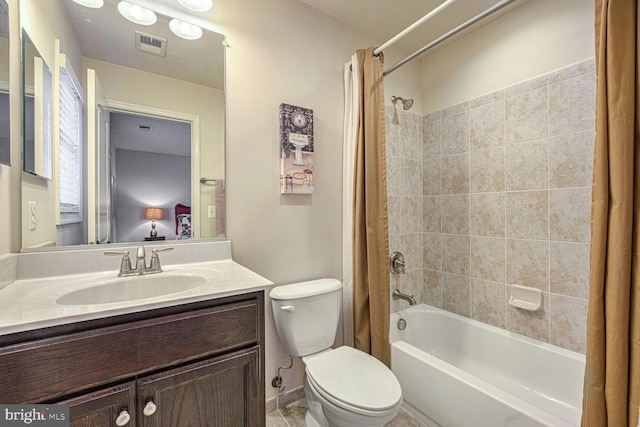 full bathroom with vanity, shower / tub combo, and toilet