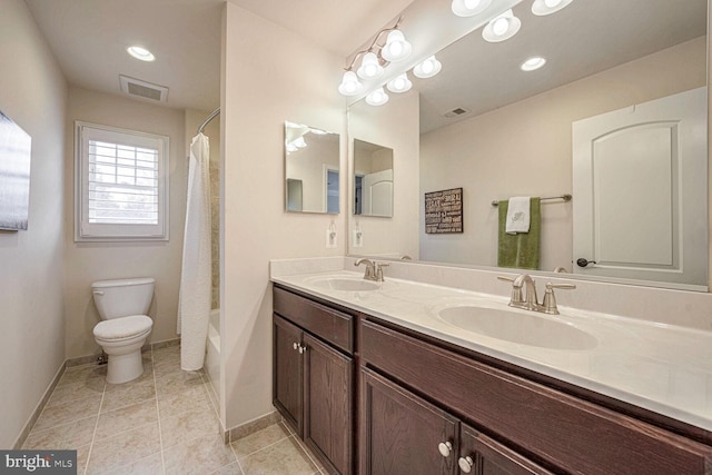 full bathroom with tile patterned floors, vanity, toilet, and shower / bath combo with shower curtain