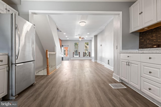 kitchen with white cabinets, ceiling fan, dark hardwood / wood-style flooring, and stainless steel refrigerator