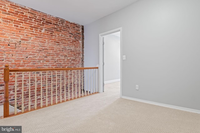 interior space featuring carpet floors and brick wall