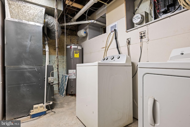 laundry area with heating unit, electric water heater, and washer and dryer