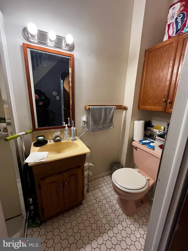 bathroom with tile patterned floors, vanity, and toilet