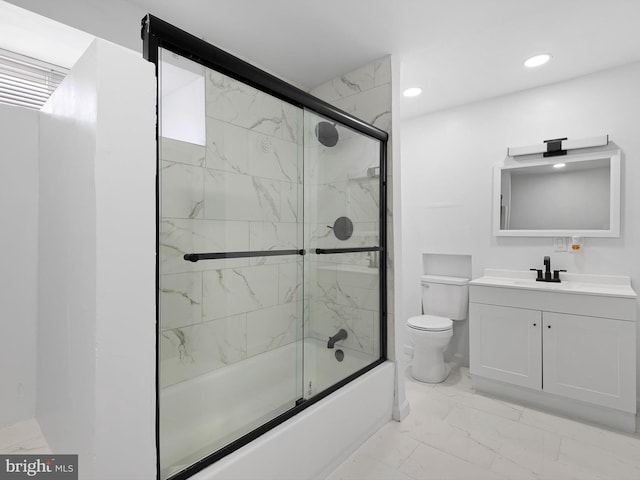 full bathroom featuring toilet, combined bath / shower with glass door, and vanity