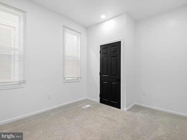 carpeted empty room featuring a healthy amount of sunlight